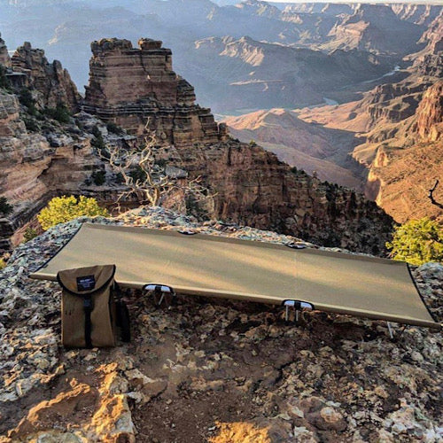 Tan GO-KOT Camping Cot on rocks overlooking canyon